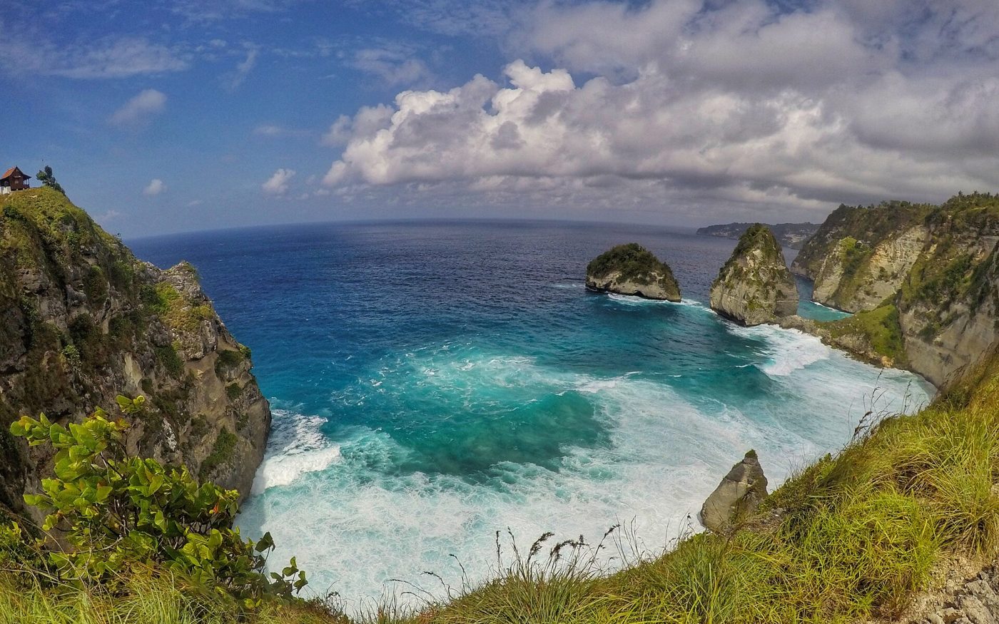 Green cliffs and a sheltered turquoise bay near Atuh Beach, Nusa Penida