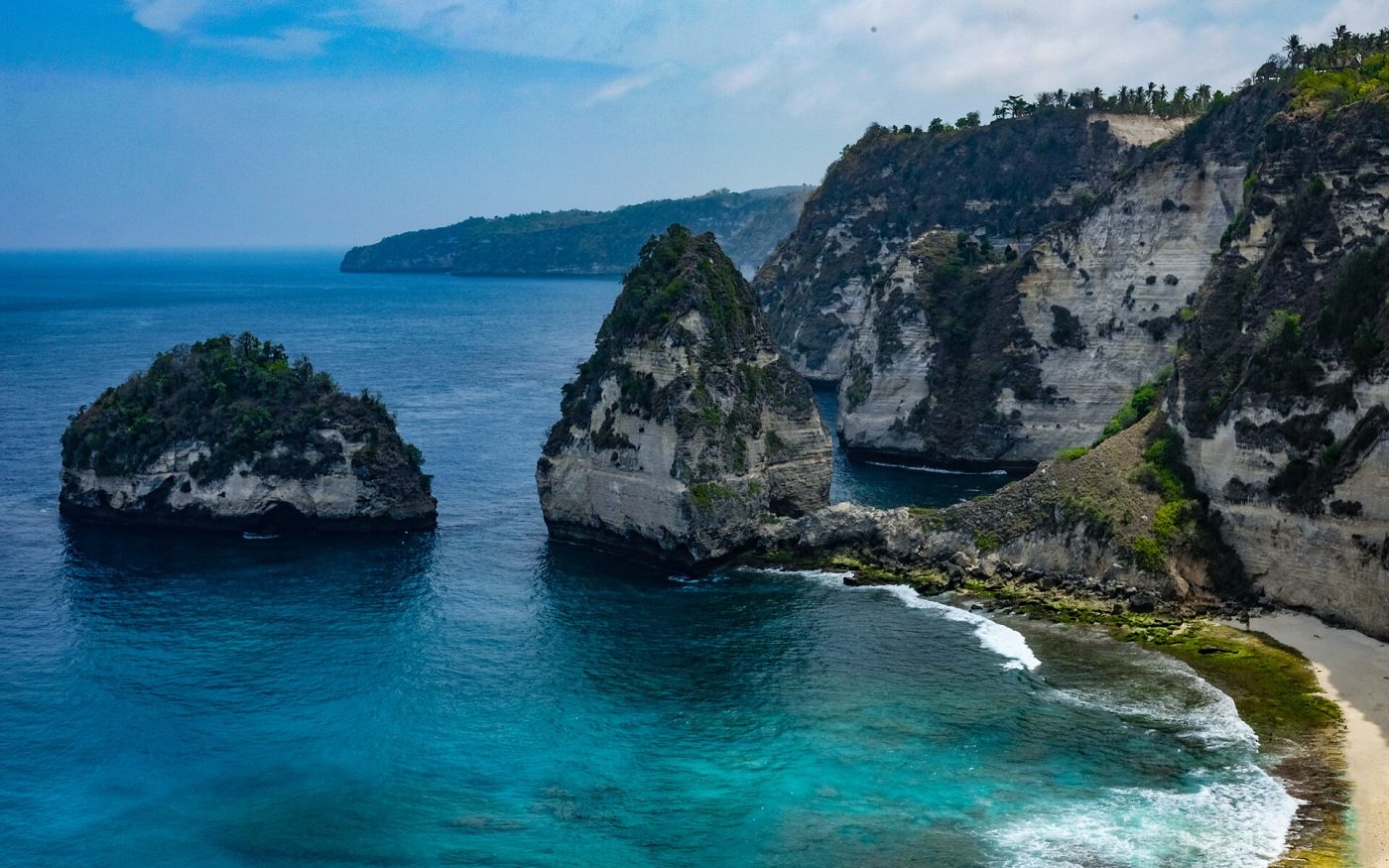 Limestone sea stacks and turquoise water at Atuh Beach on Nusa Penida