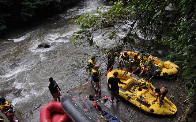 Inflatable rafts and guides getting ready on the bank of the Ayung River, Bali