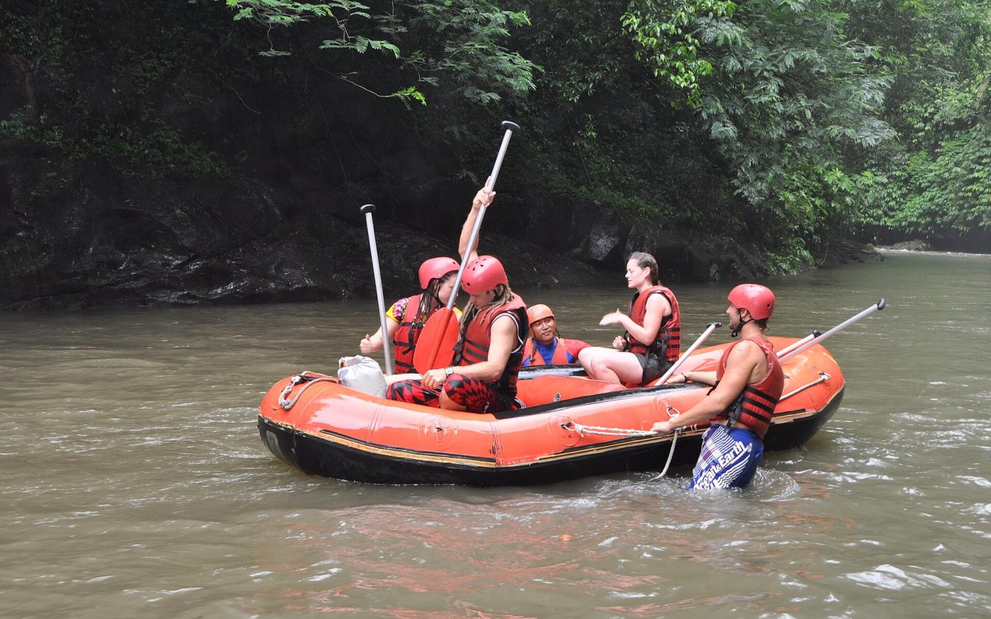 Rafters in helmets paddling an inflatable raft on the Ayung River, Bali