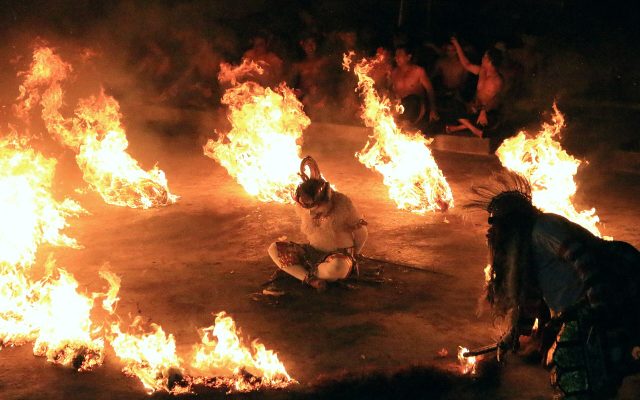 Hanuman dancer among burning coconut husks during the Kecak fire dance at Uluwatu