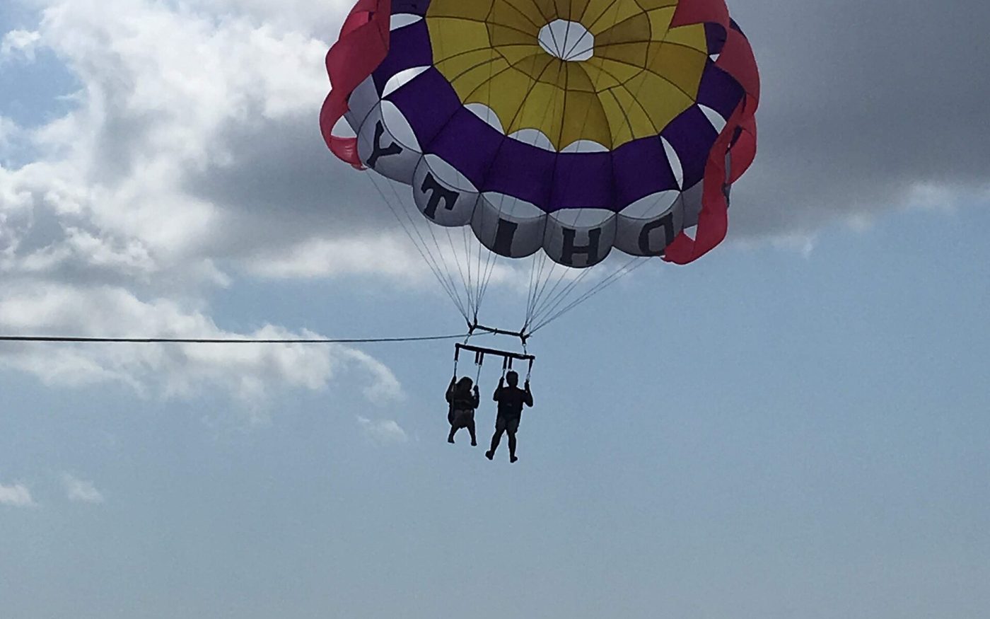 Parasail flying over the sea at Tanjung Benoa water sports area, Bali