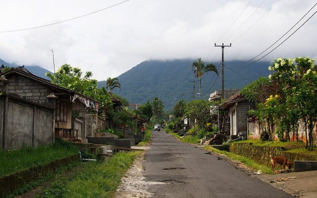 Quiet countryside road to Jatiluwih with village houses and mountains in Bali