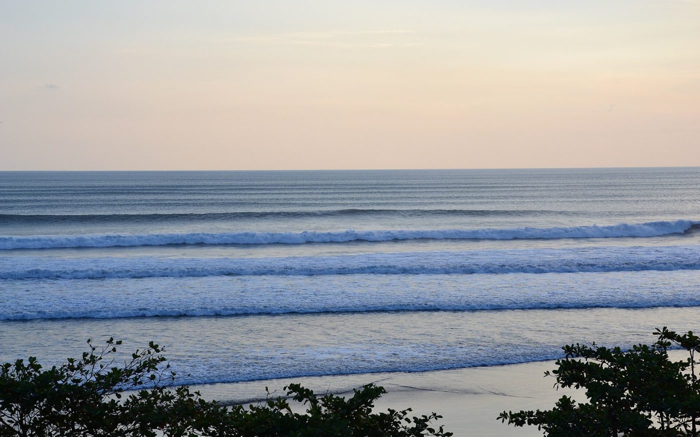 Rows of breaking waves rolling into Seminyak beach, Bali