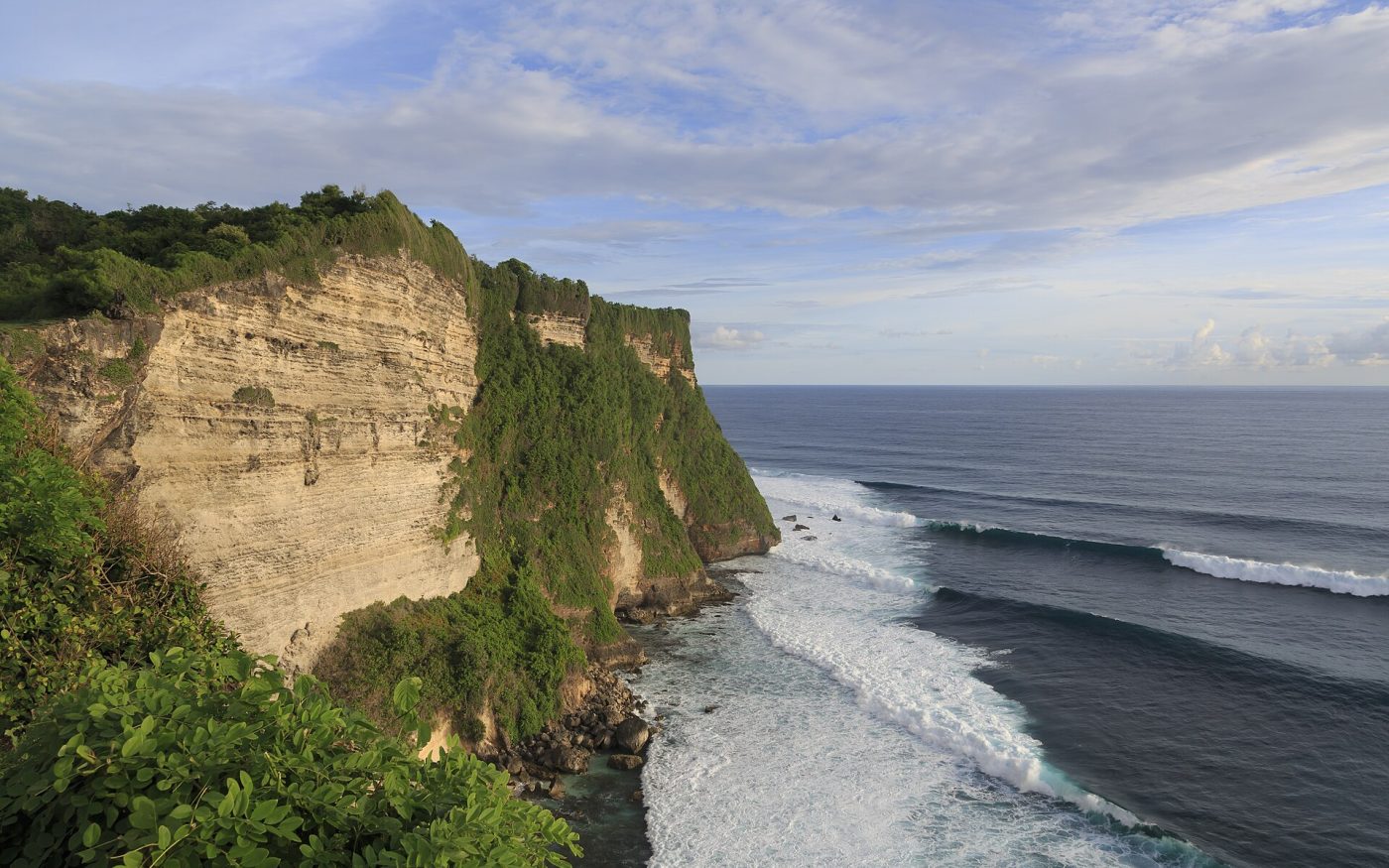 Sheer limestone cliffs and white surf lines below Pura Luhur Uluwatu